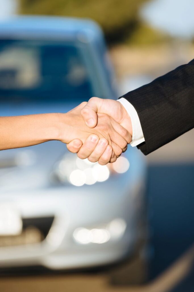 Collecting rental car and Shaking Hands; Tedi Autos Hire Car in the background.